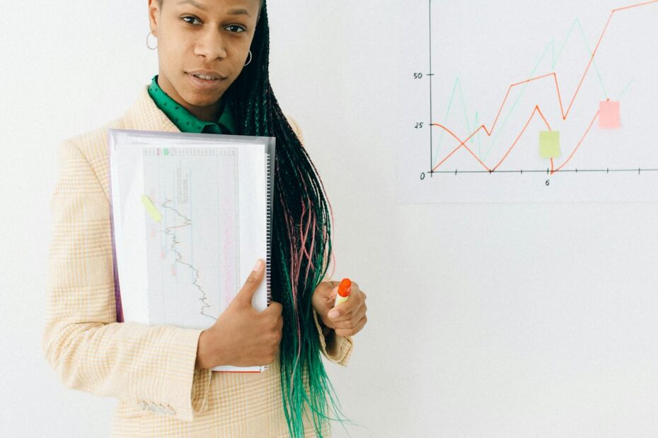 Confident analyst presenting financial data and growth charts in a modern office setting.